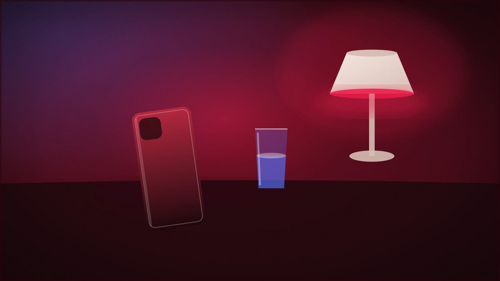 A phone lying face-down on a bedside table next to a glass of water in warm low light.